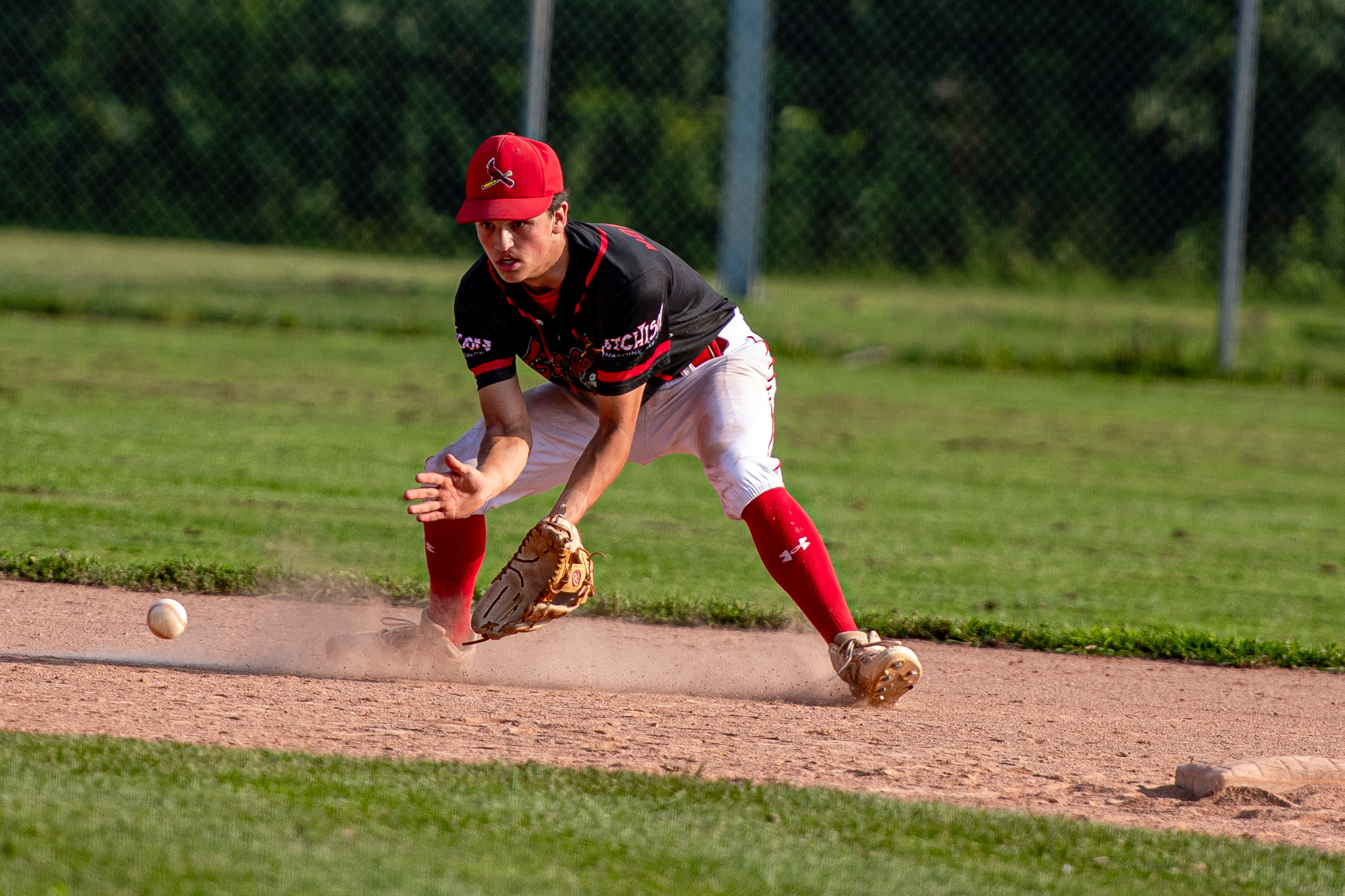 St. Thomas Cardinals Ryan Morrison sets to scoop the ball.