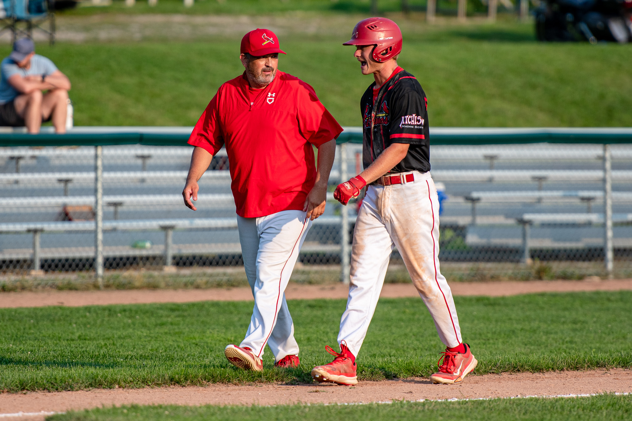 St. Thomas Cardinals manager Ryan Morrison with base runner Wyatt Atchison.