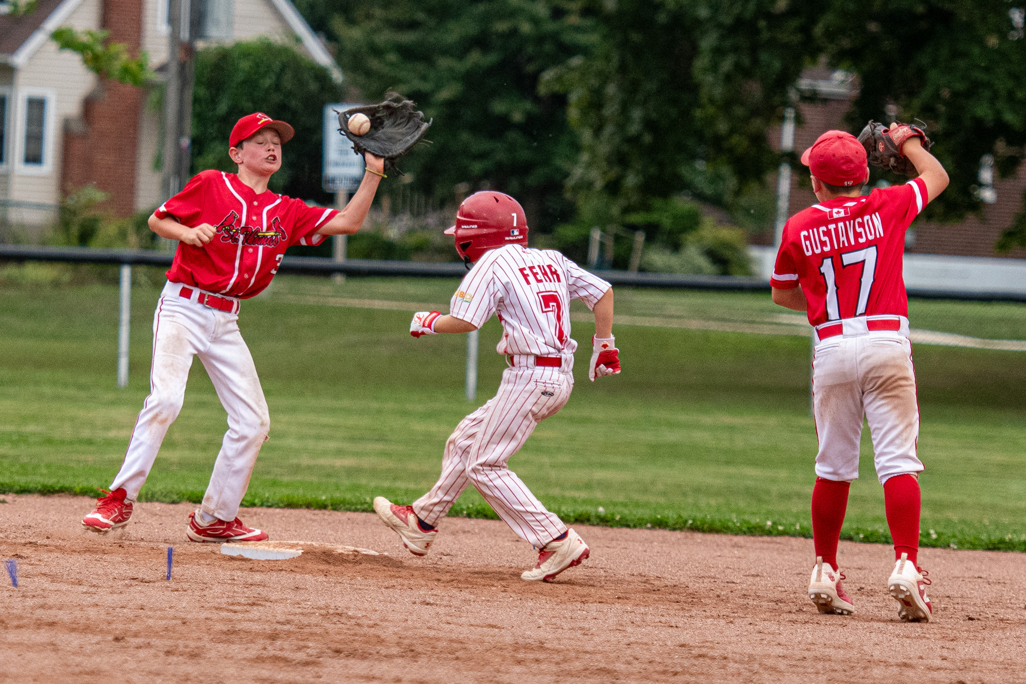 St. Thomas Cardinals shortstop Ben Wakefield makes an out at second base from a throw by Brett Gustavson.