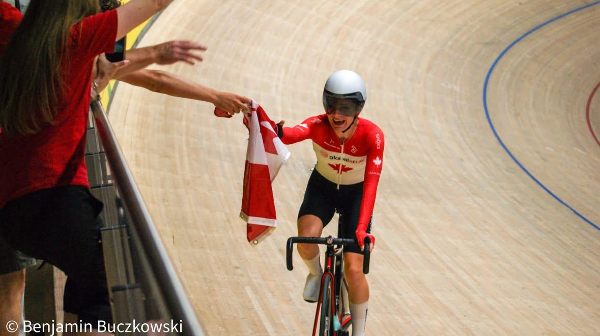 Eve Buczkowski is handed a Canadian flag for a victory lap. (photo / Ben Buczkowski)