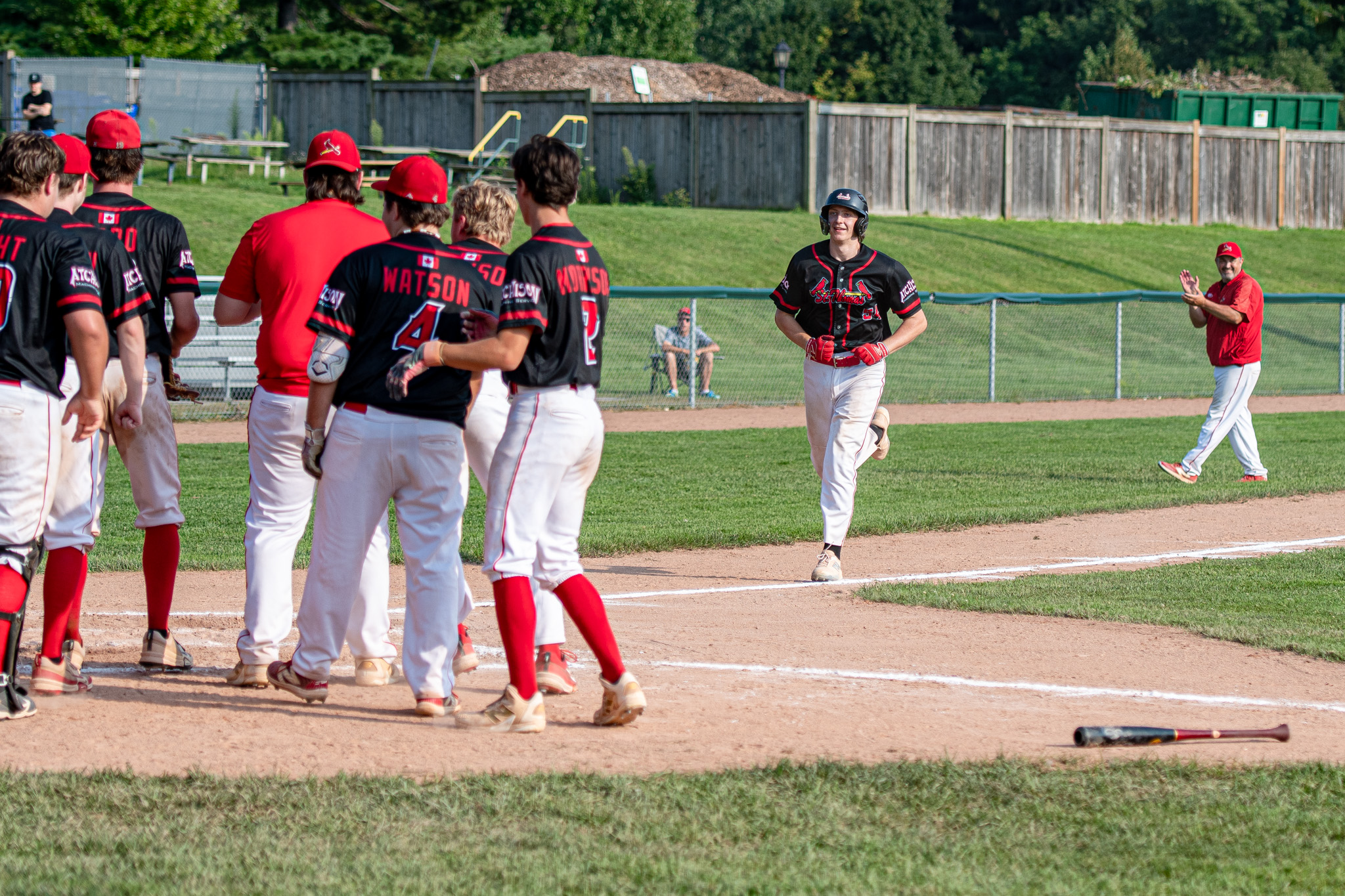 The St. Thomas Cardinals wait to celebrate Andrew Oakes' three run blast.