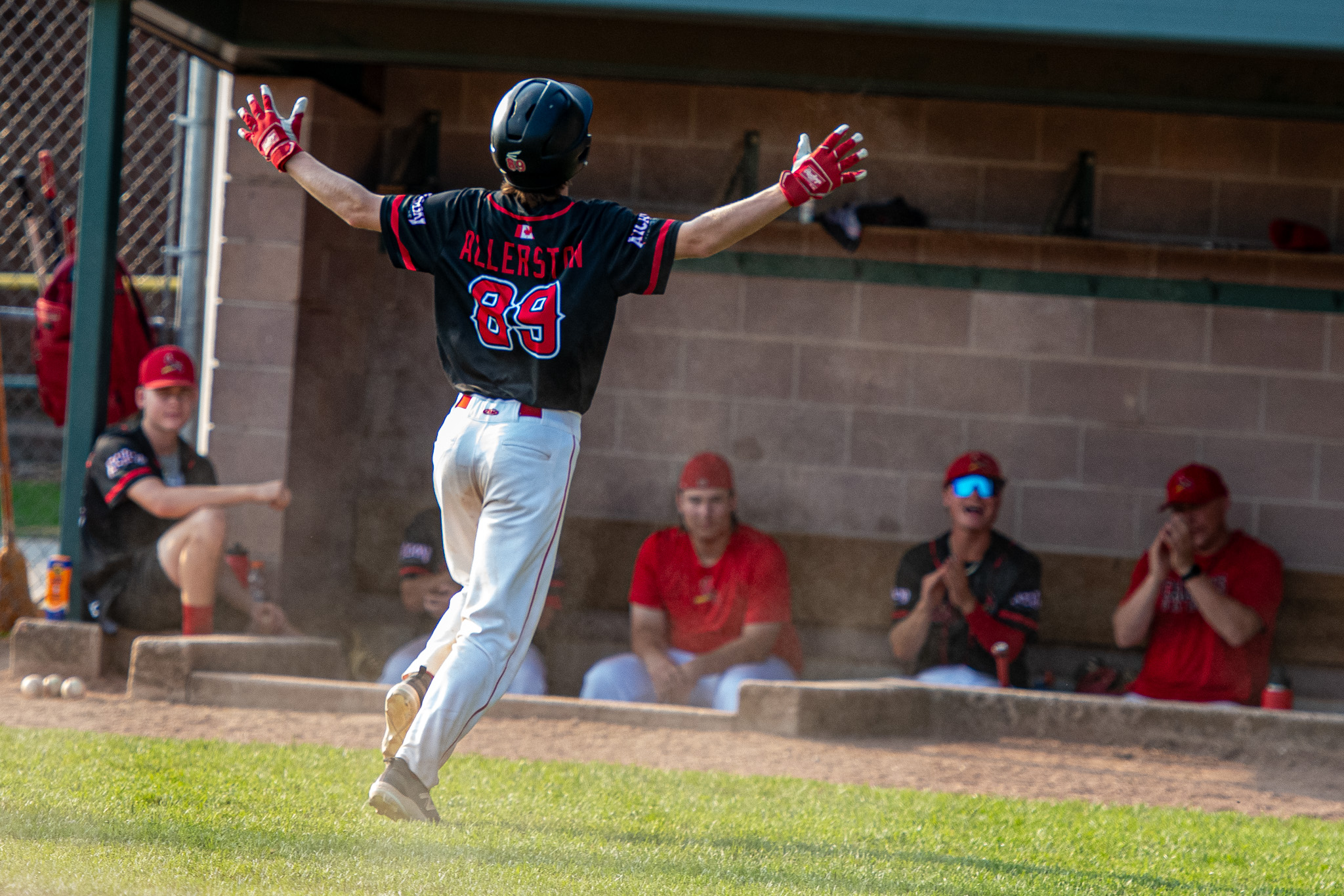 St. Thomas Cardinals Wyatt Allerston celebrates scoring a run.