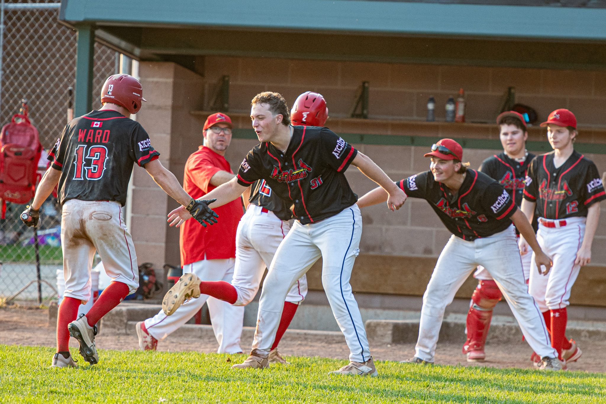 The St. Thomas Cardinals celebrate Aiden Ward scoring for a third time in the game.