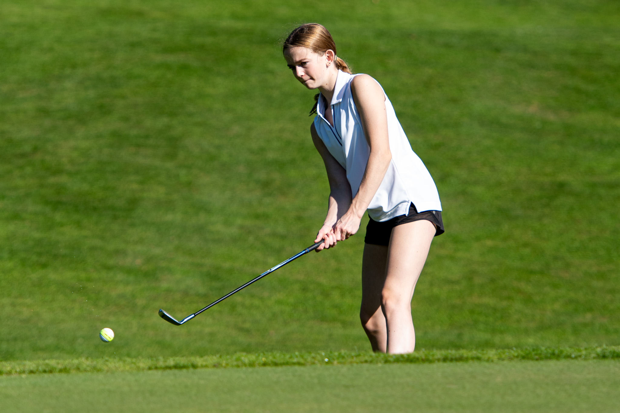 Huron Park Huskies Abby Lichty chips on to the greens.